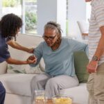 Caregiver assisting senior woman in a long-term care facility