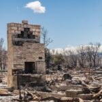 Brick fireplace and stands amidst the burned remains of a wildfire