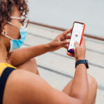 Woman posting on social media in public