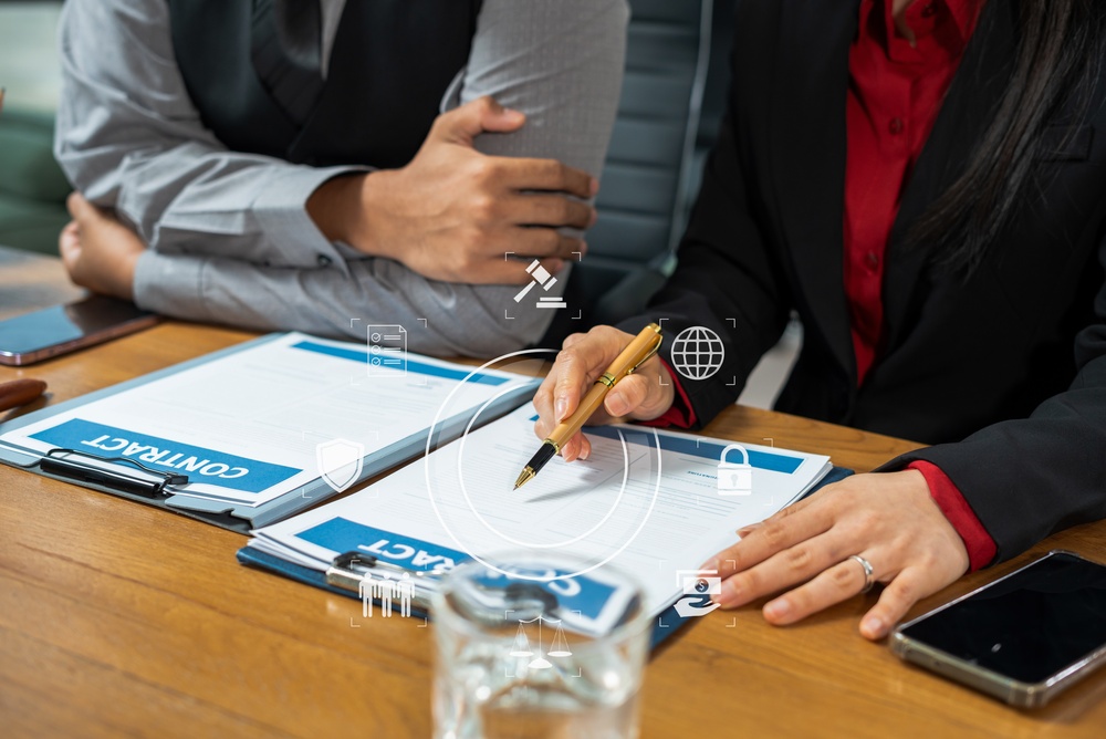 Lawyers diligently reviewing an insurance contract to support a client with long-term disability compensation