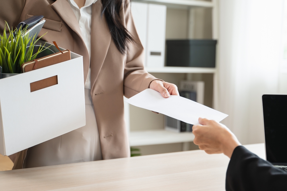 Woman receiving severance paperwork after job loss